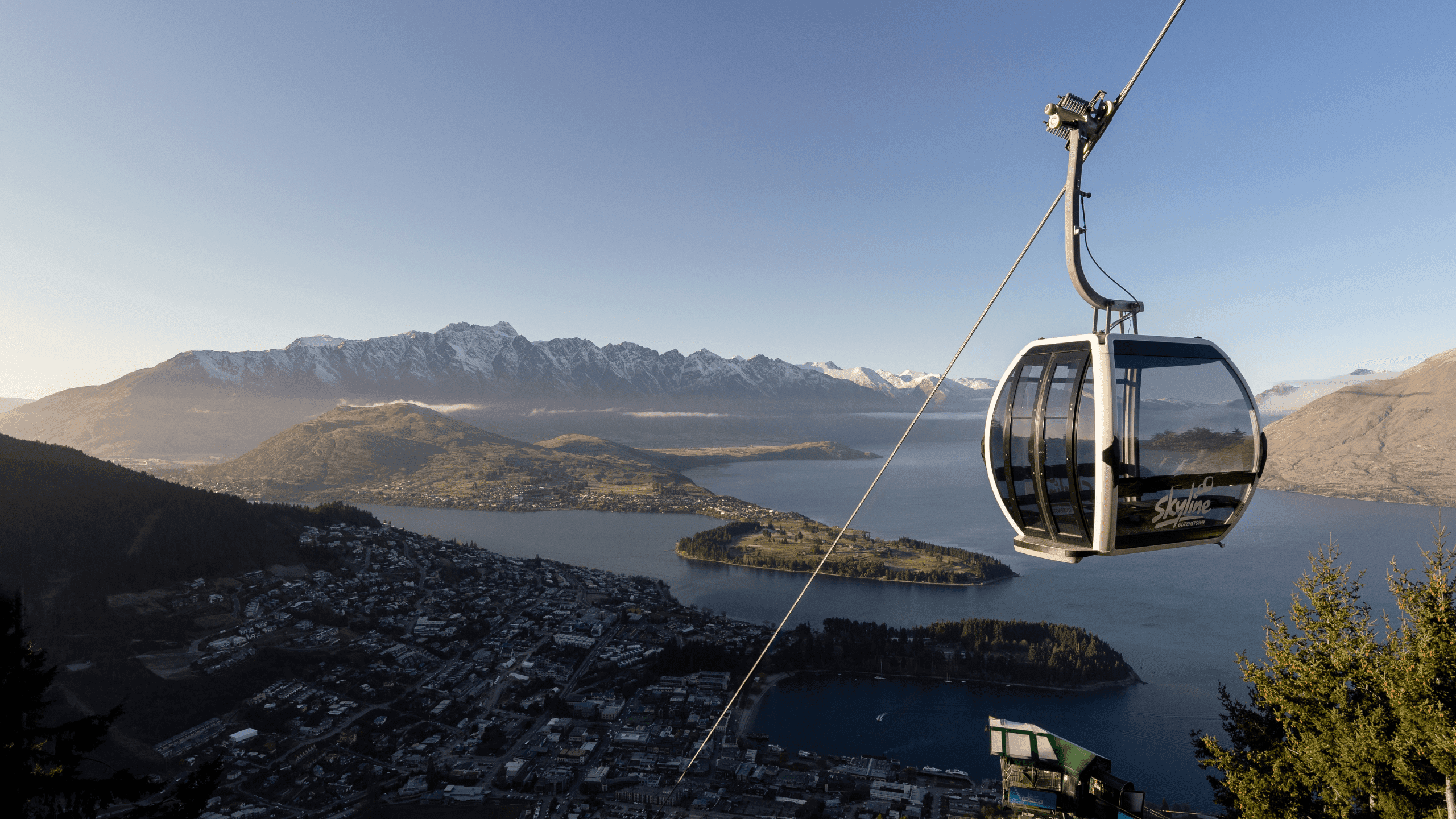 Image of the Queenstown Gondola with blue sky in the background high in the air