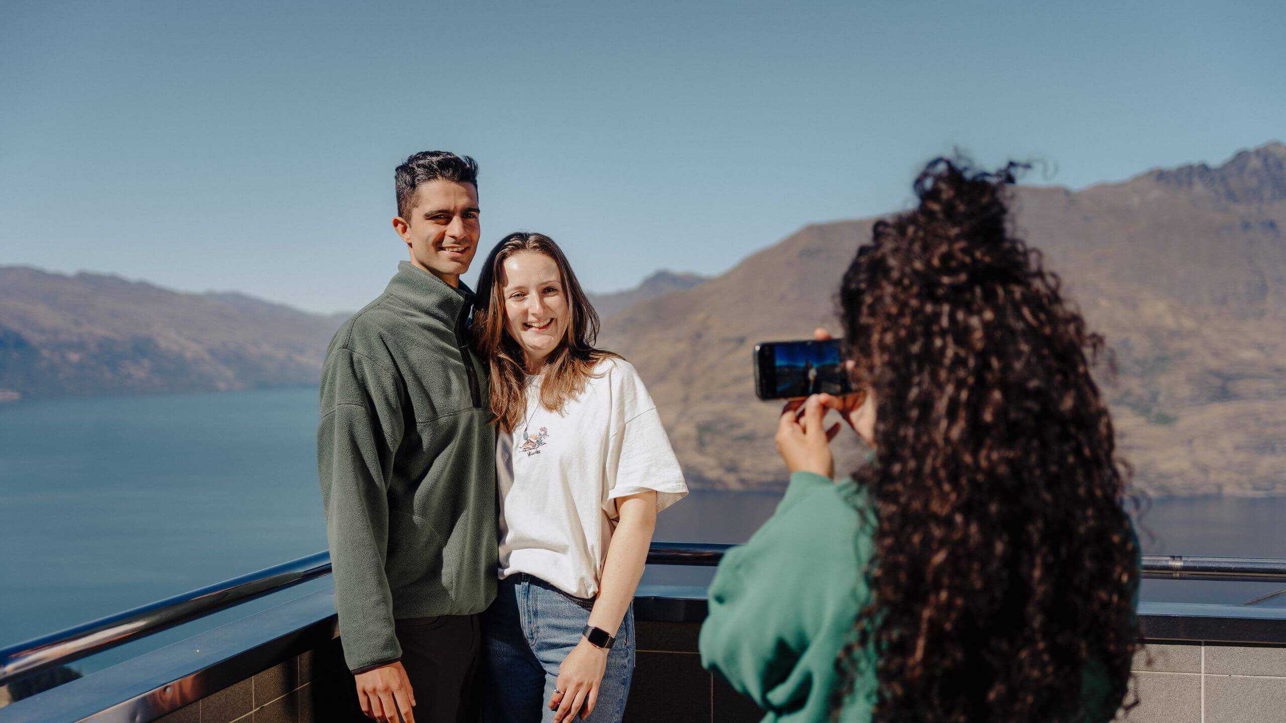 Visitors enjoy panoramic views from Skyline Queenstown’s viewing deck overlooking Lake Wakatipu and The Remarkables mountain range.