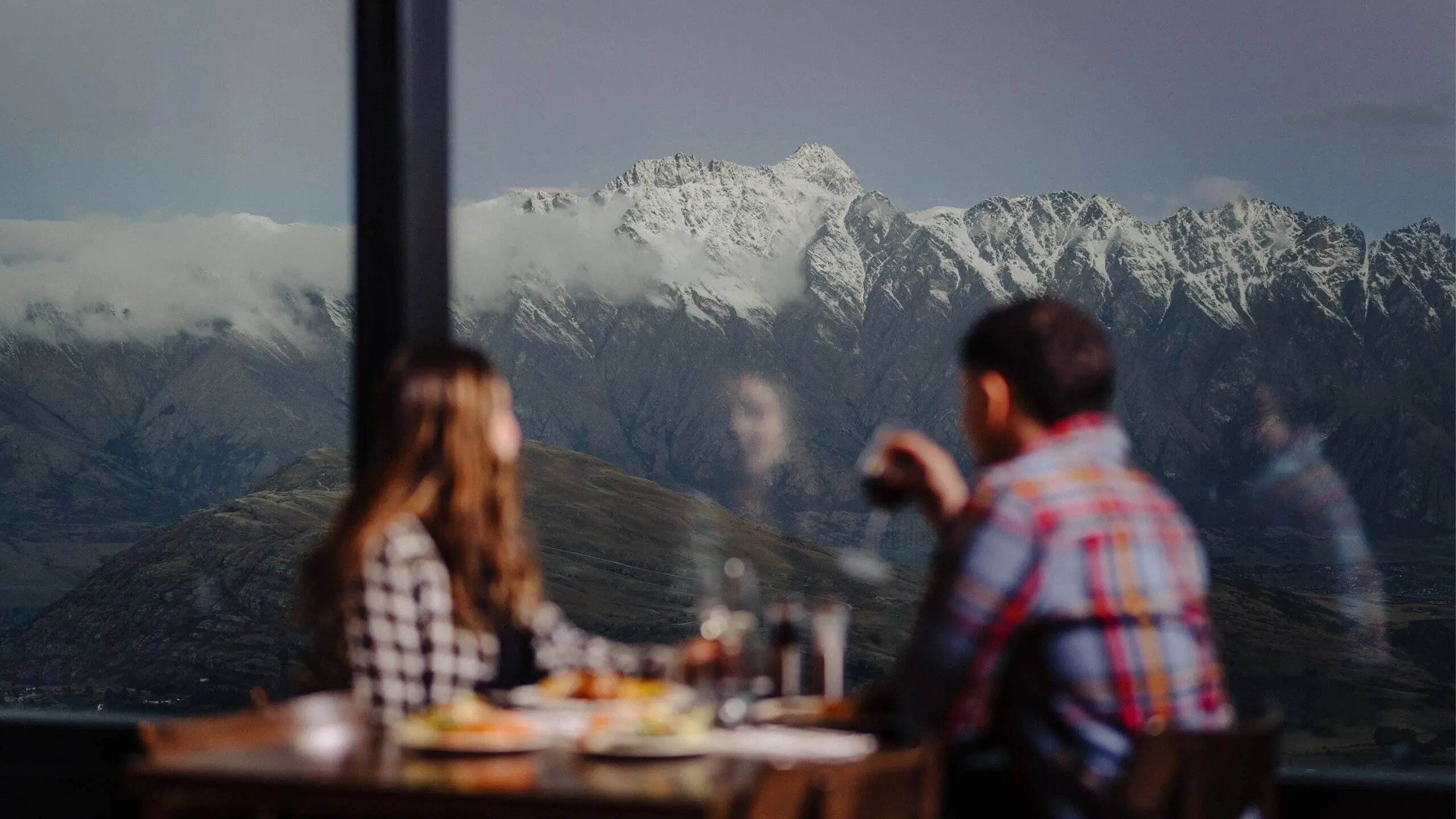 Dining at Stratosfare Restaurant overlooking the Remarkables mountain range and alpine landscapes in Queenstown.
