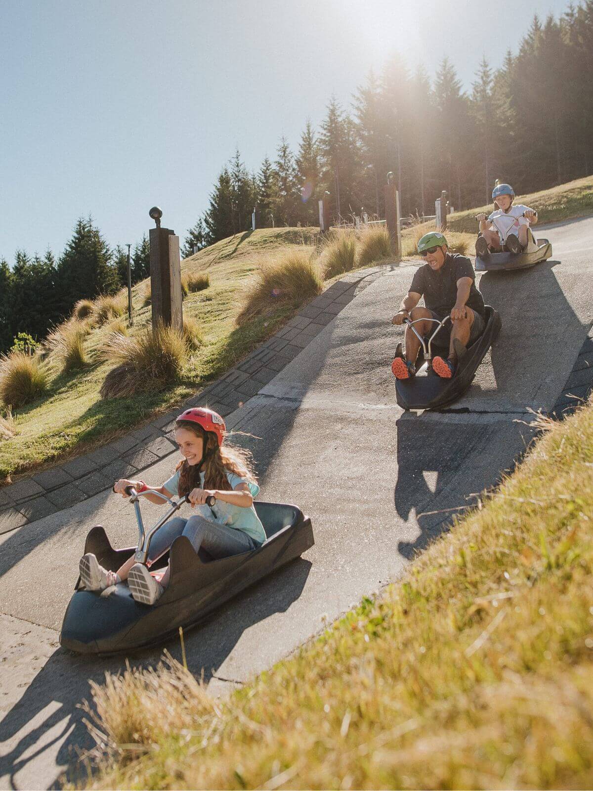 Three people riding on the Luge