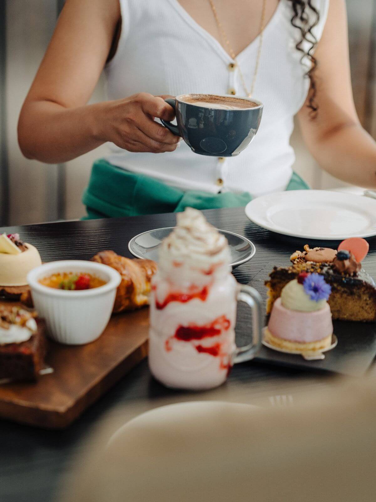 Pastries and milkshake with coffee being picked up