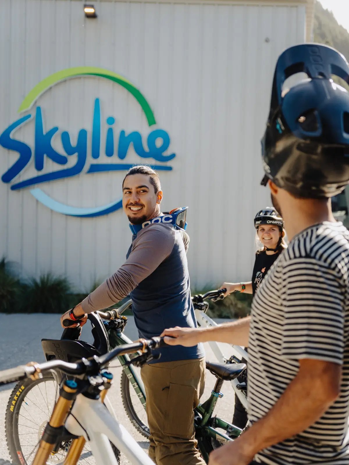 Mountain bikers preparing to ride at Skyline Queenstown's gondola base station before accessing the Ben Lomond mountain bike trails.