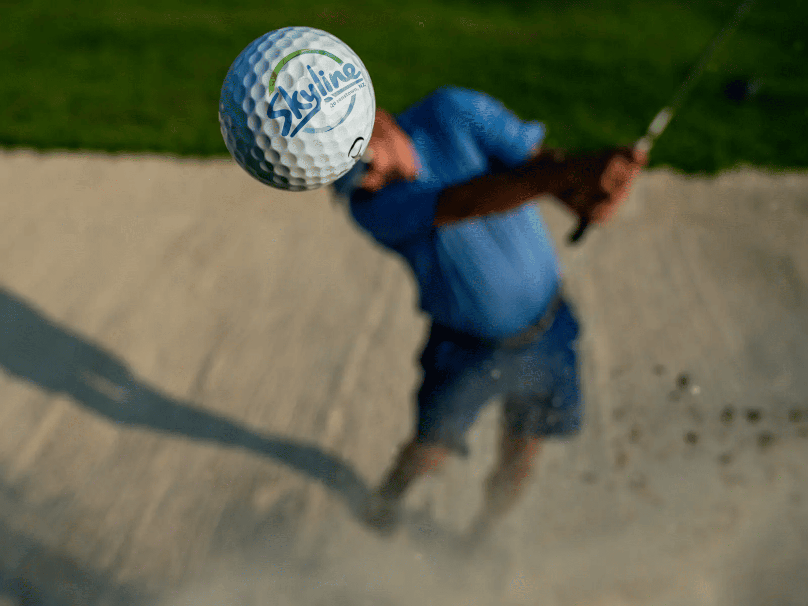 Close-up of a golf ball in flight after a bunker shot during the Skyline Charity Golf Classic in Queenstown.