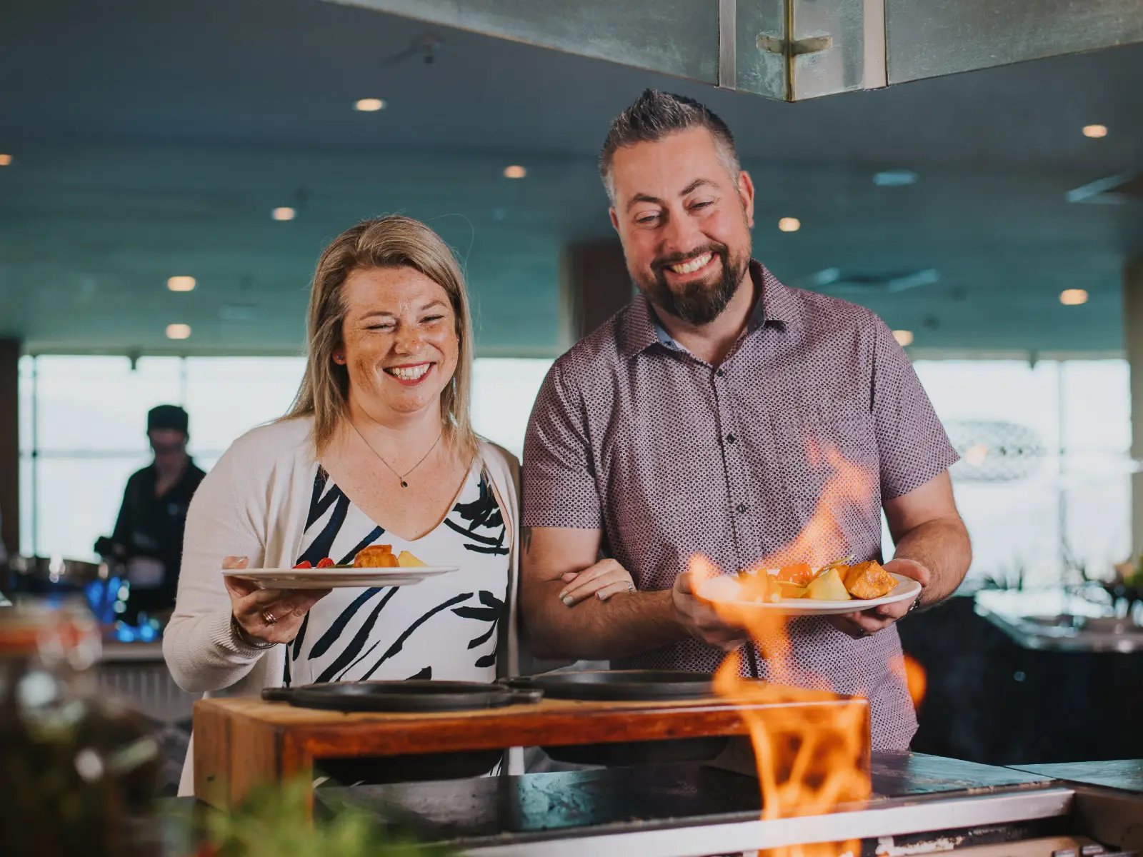 Guests selecting freshly prepared food from the live cooking station at Stratosfare Restaurant at Skyline Queenstown