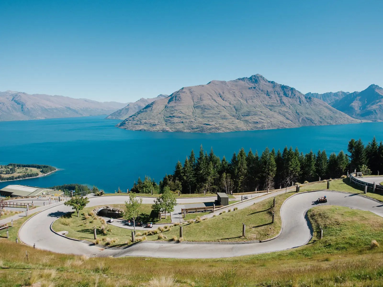 Skyline Queenstown Luge tracks winding down the hillside with panoramic views over Lake Wakatipu