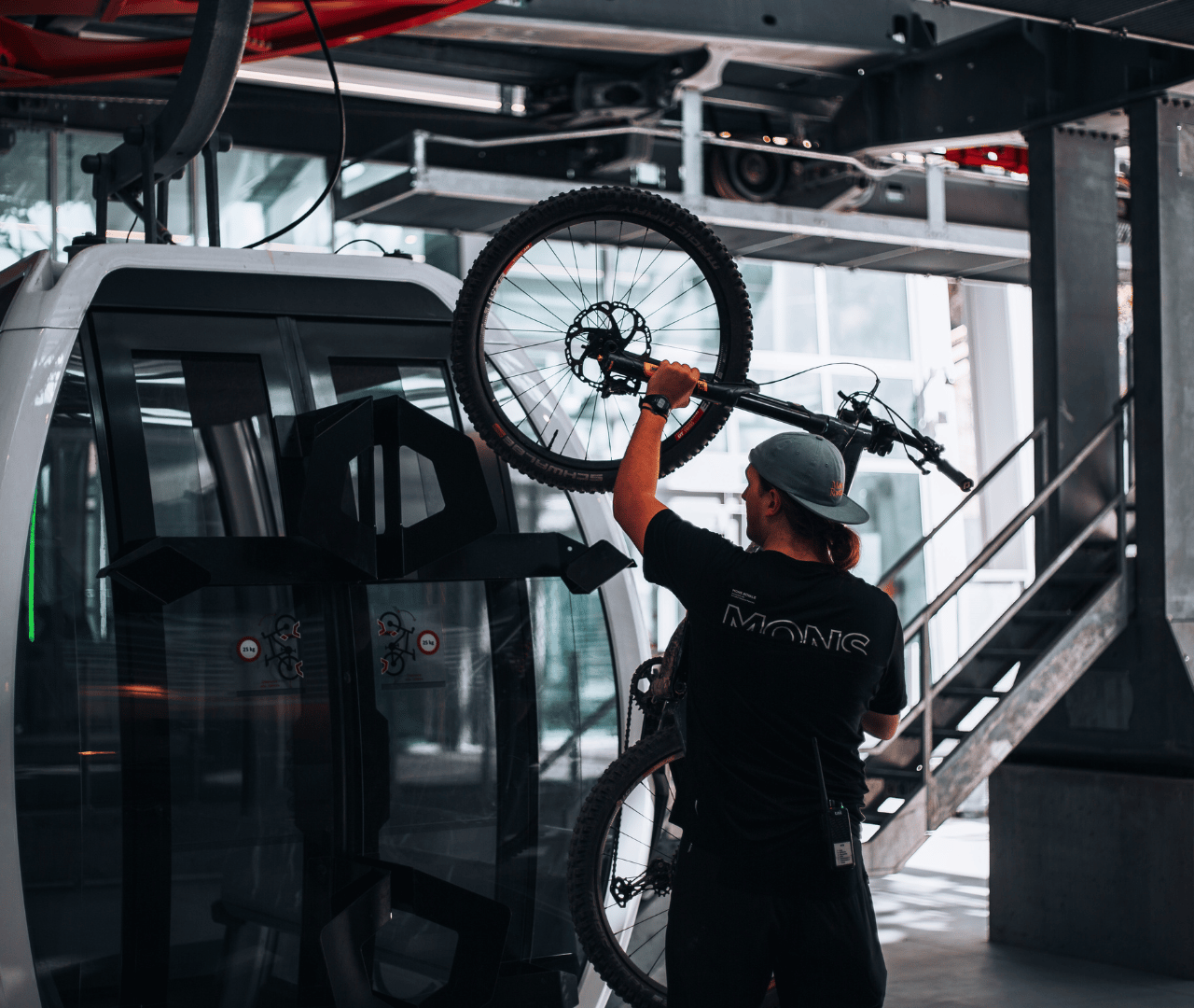 A staff member loads a customer's bike onto a Gondola at Skyline Queenstown.
