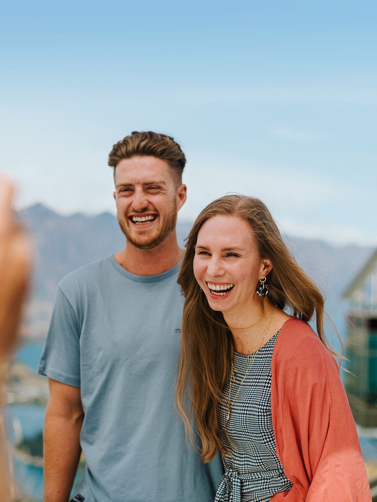 Couple on top of mountain posing for photo