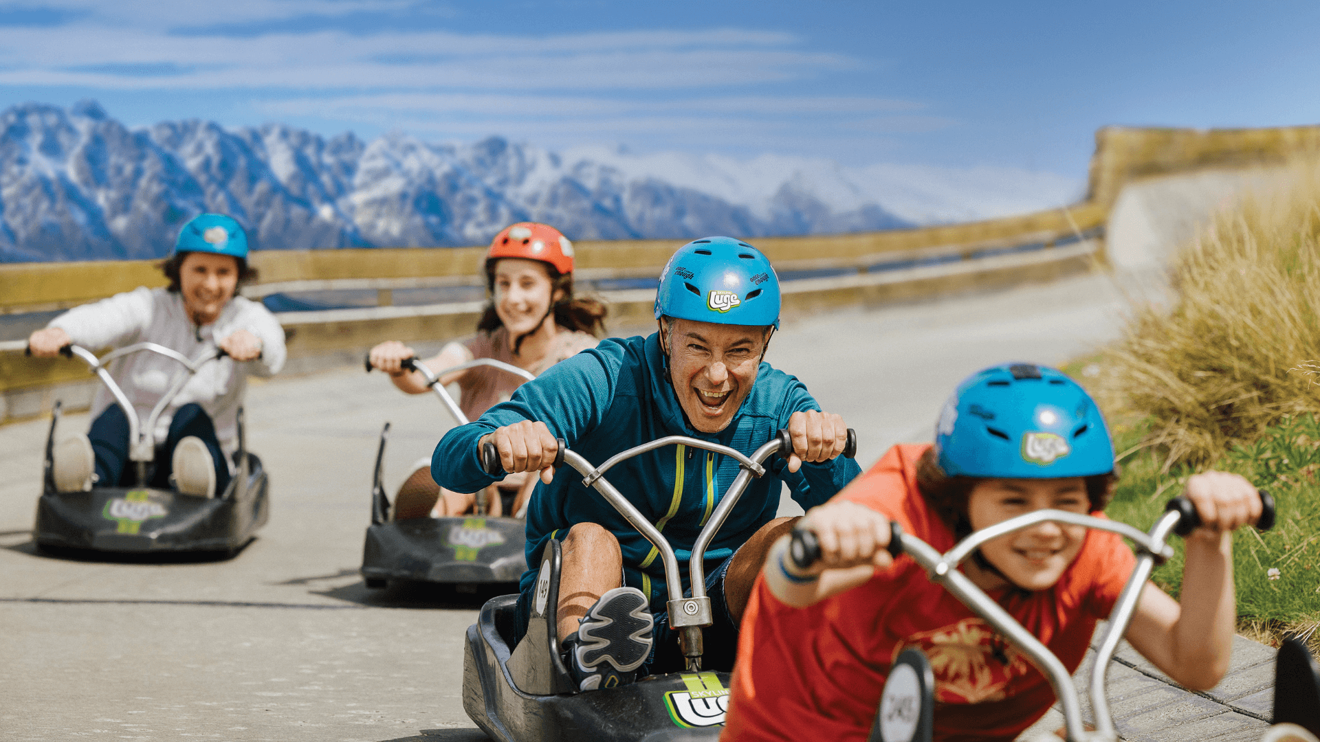 People going down the Luge track in Queenstown