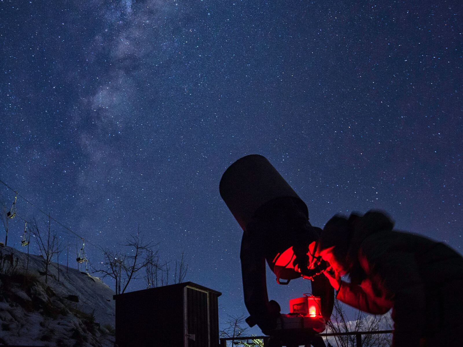 A telescope being pointed up towards the nights sky